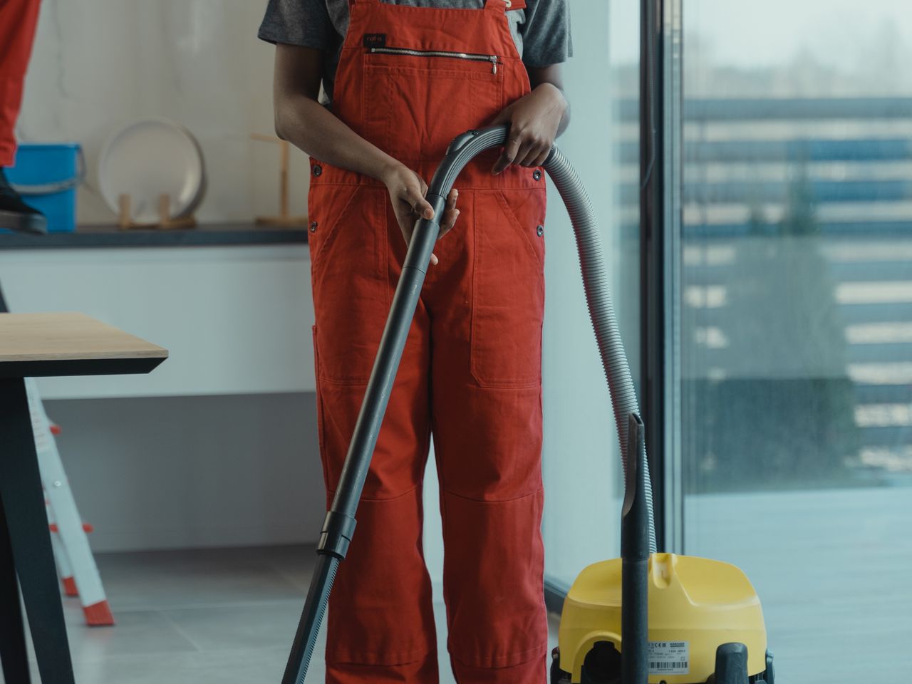 Housekeeping technician vacuuming a commercial office floor